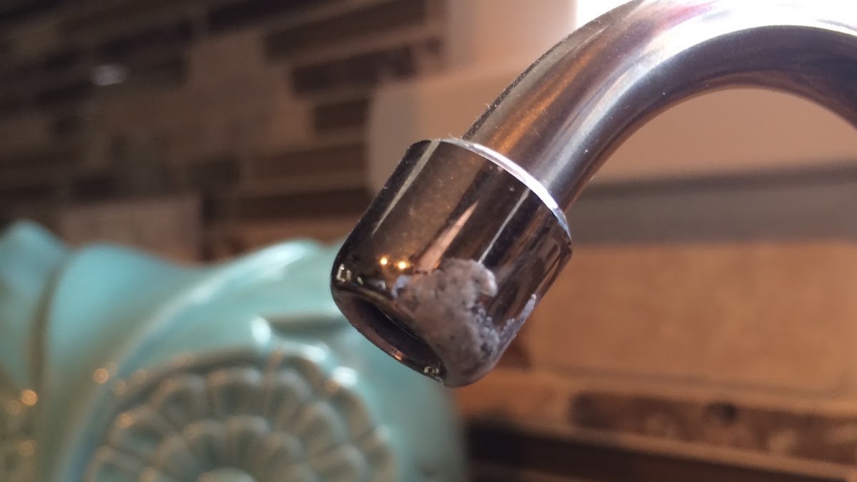 Instead of Scrubbing Hard Water Buildup, She Tied a Bag of Vinegar Around the Kitchen Faucet