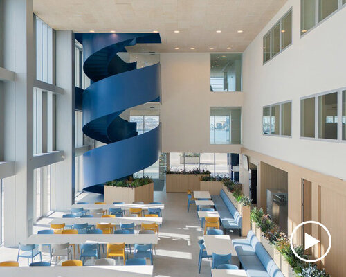blue spiral staircase anchors ERRE’s harbor-side workspace in valencia